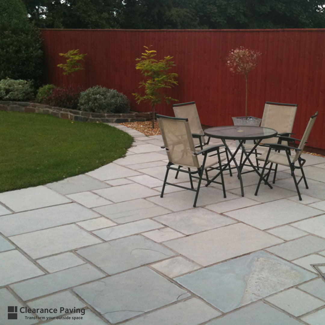 Limestone square patio slabs in Ocean Spray with garden furniture