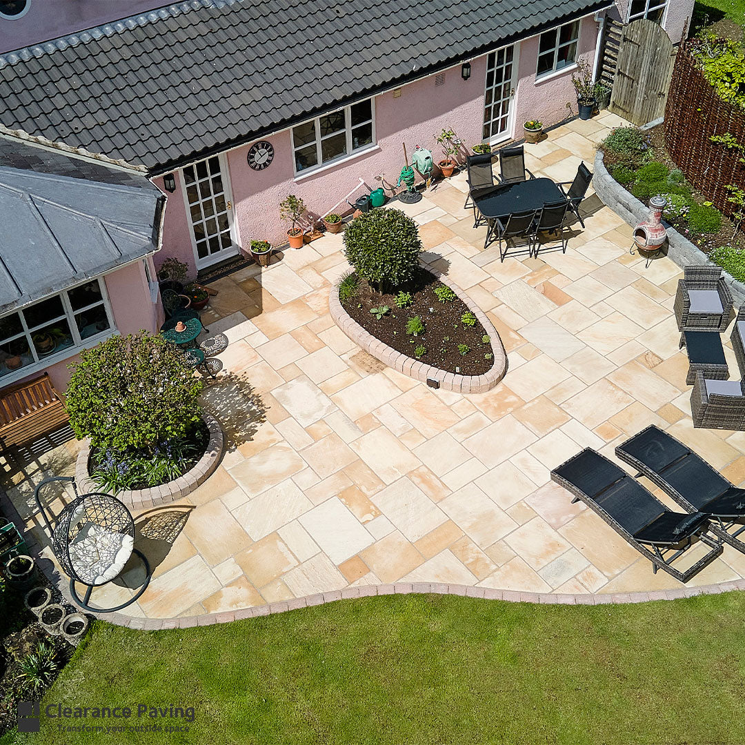Indian Sandstone multi sized paving slabs in Fossil Mint with lawned area